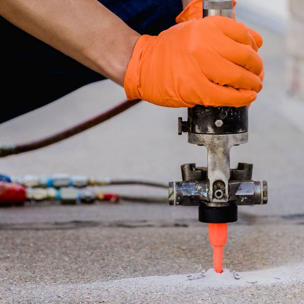 Crew leveling a sunken concrete slab