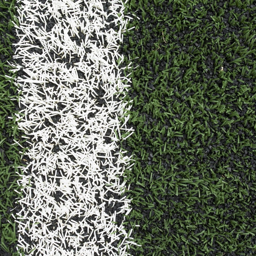 Artificial green grass background with white line