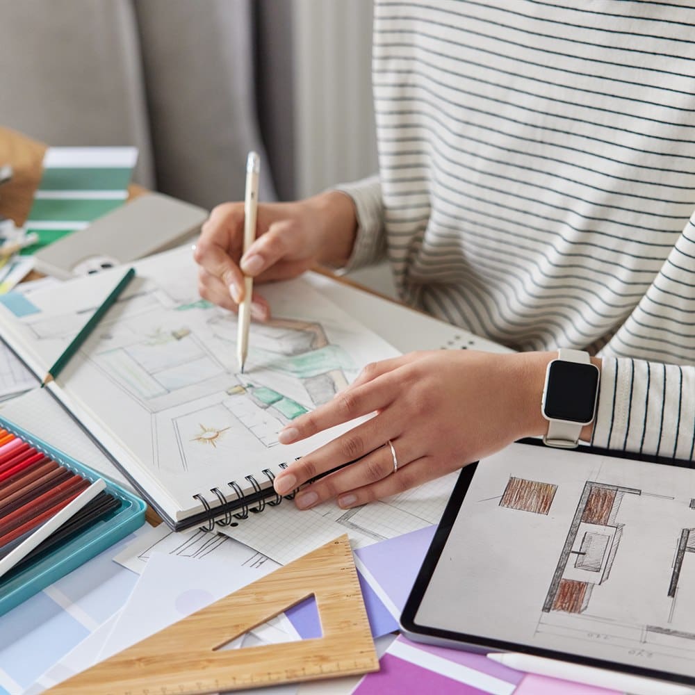Designer sketching interior on digital tablet
