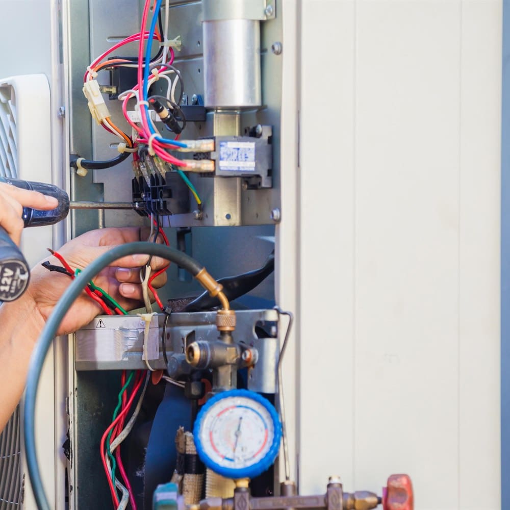 Hvac technician working on air conditioning unit