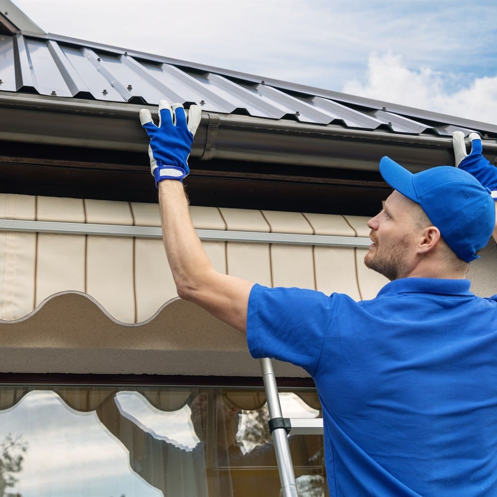 Installing gutter under metal roof