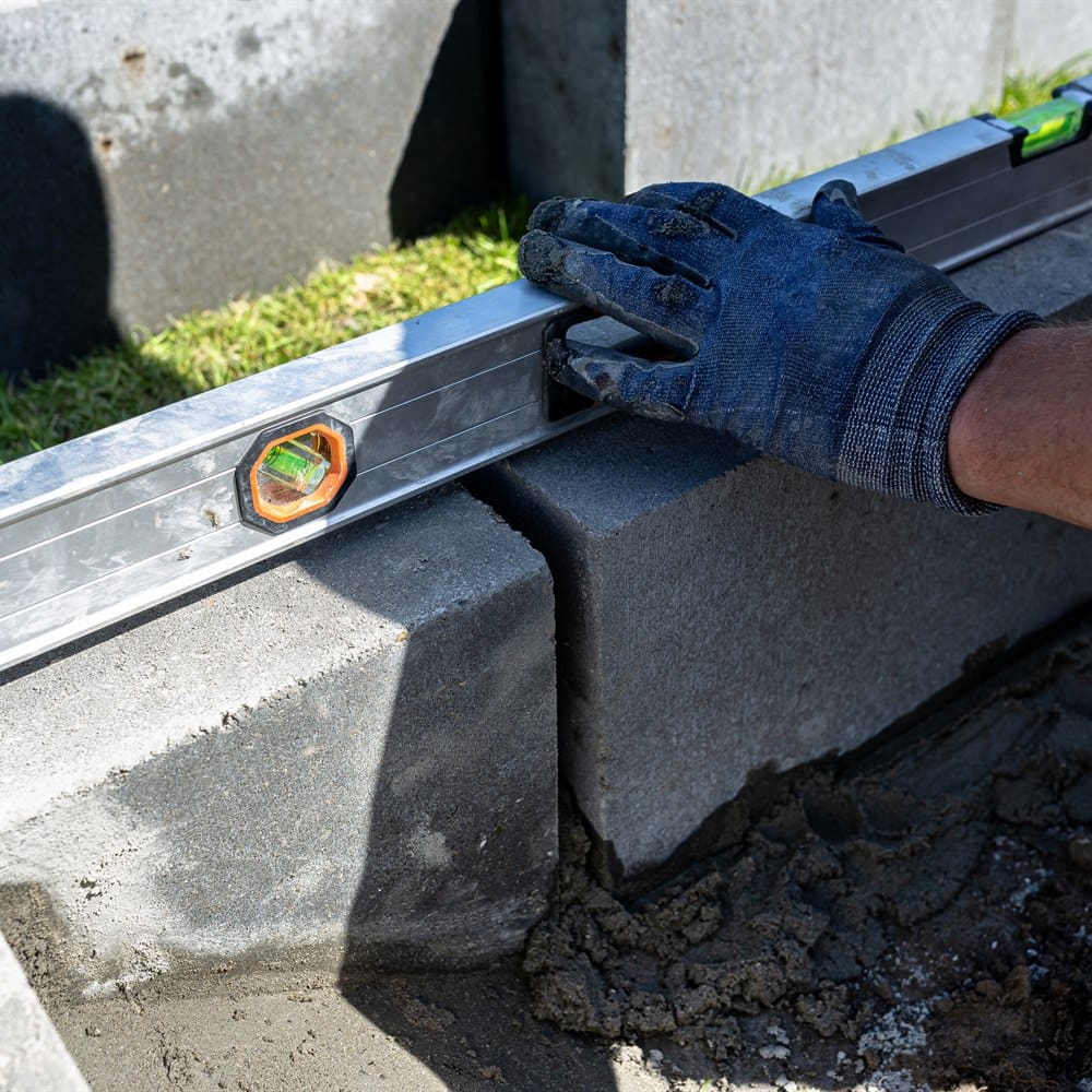 man-using-level-building-with-cinder-blocks Man using level building with cinder blocks