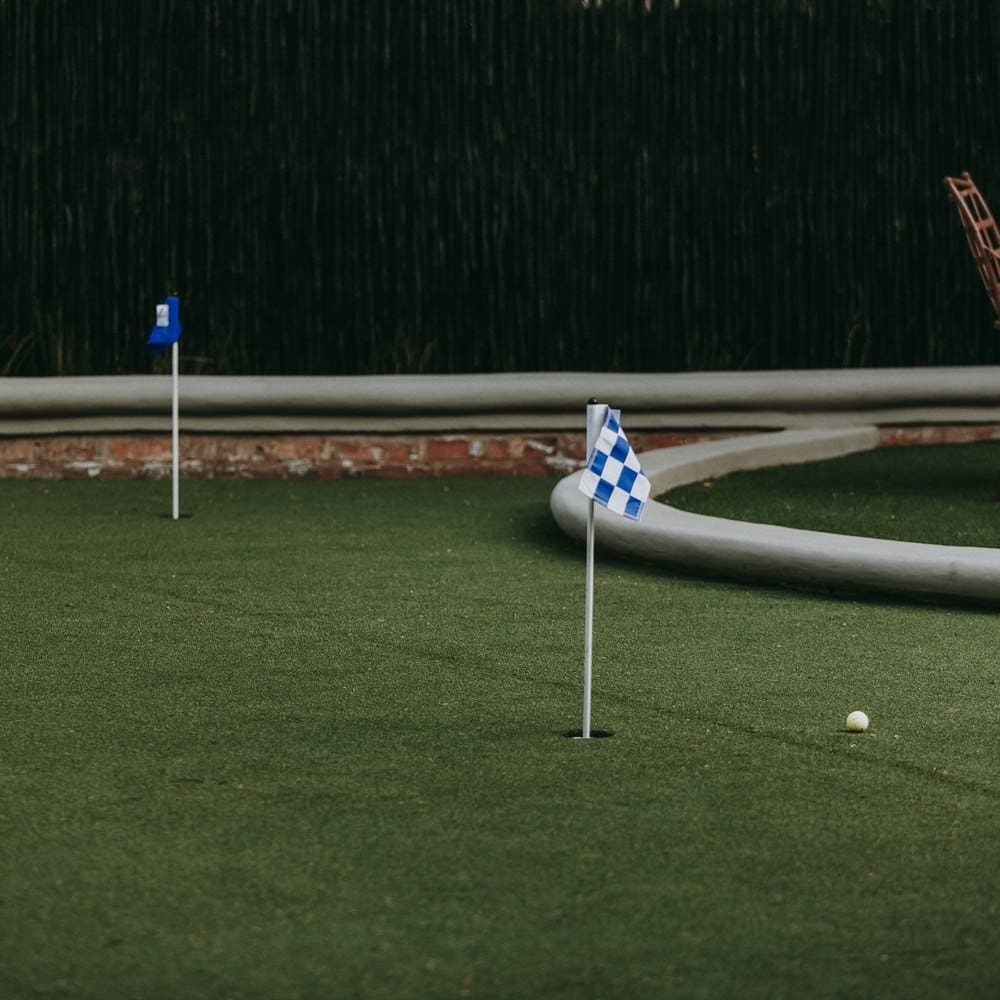 Miniature golf course with blue and white flags
