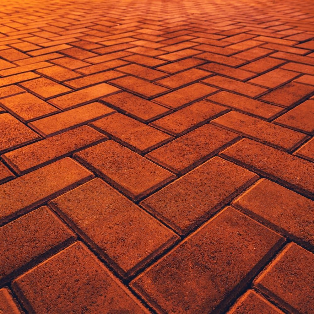 Orange bricks in herringbone pattern at night