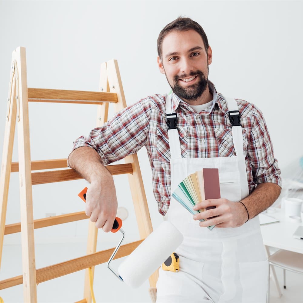 Painter with roller and colour swatches