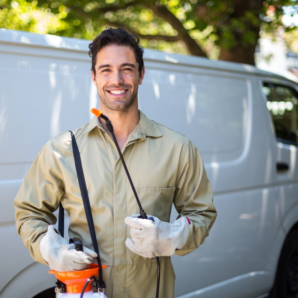 Pest control technician with a sprayer