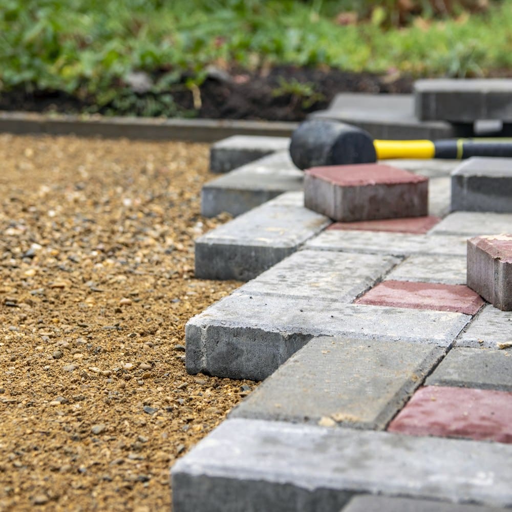 setting-pavers-with-a-rubber-mallet Setting pavers with a rubber