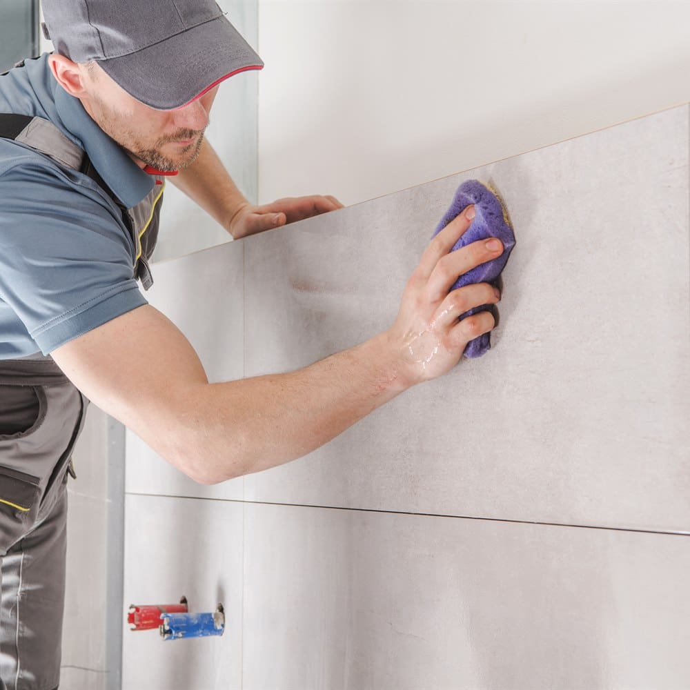 sponging-grout-from-wall-tile Sponging grout from wall tile