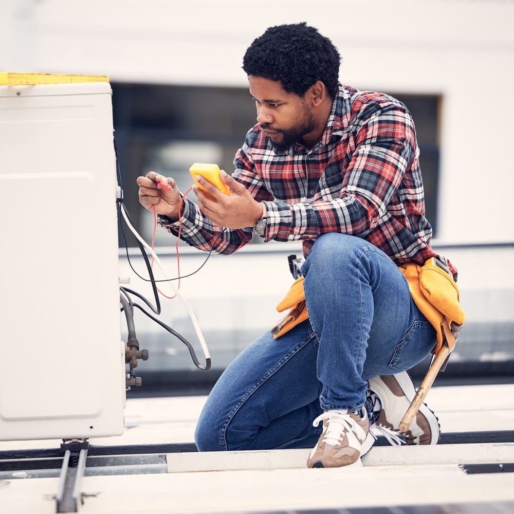 Technician repairs air conditioner system on build