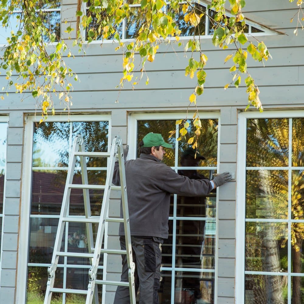 working-on-house-windows-from-ladder Working on house windows from ladder